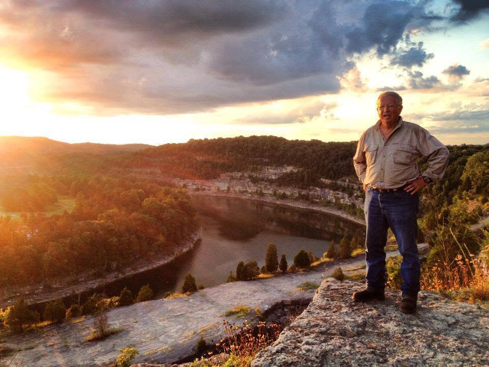 Boyd Haley outdoors at sunset overlooking a river valley.